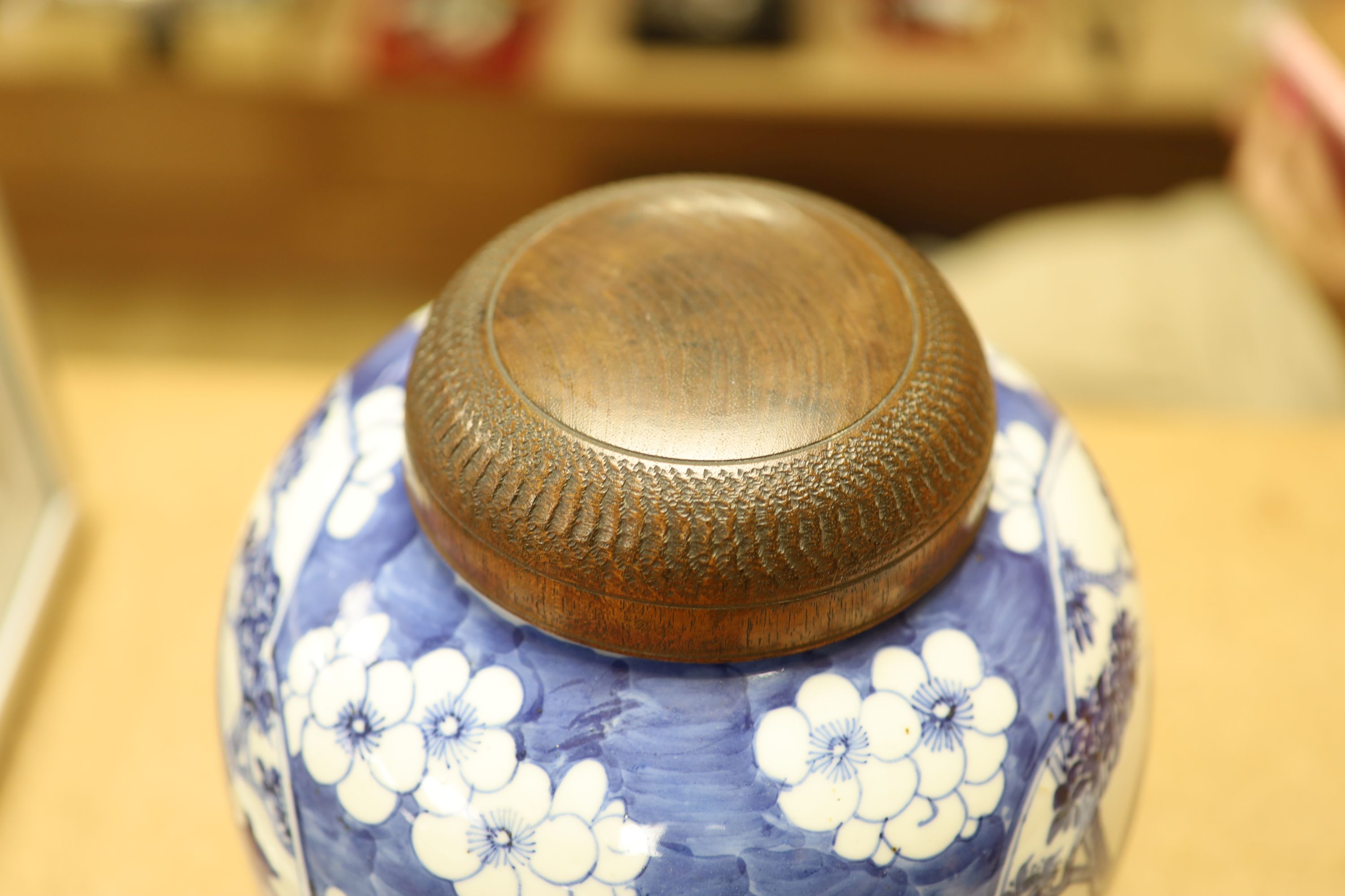 A late 19th / early 20th century Chinese blue and white jar, with wooden cover, height 25cm
